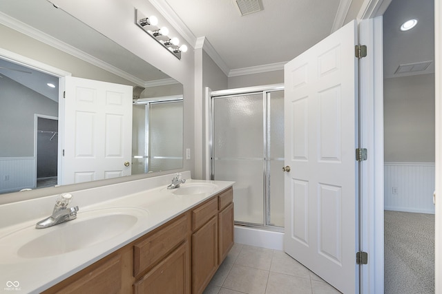 bathroom with tile patterned floors, crown molding, vaulted ceiling, vanity, and a shower with door