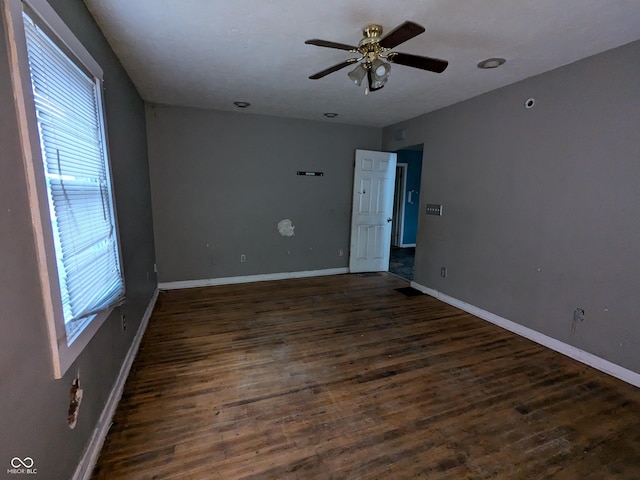 spare room with ceiling fan and dark hardwood / wood-style flooring