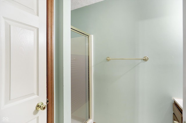 bathroom featuring a shower with shower door