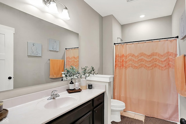 bathroom with tile patterned flooring, vanity, curtained shower, and toilet