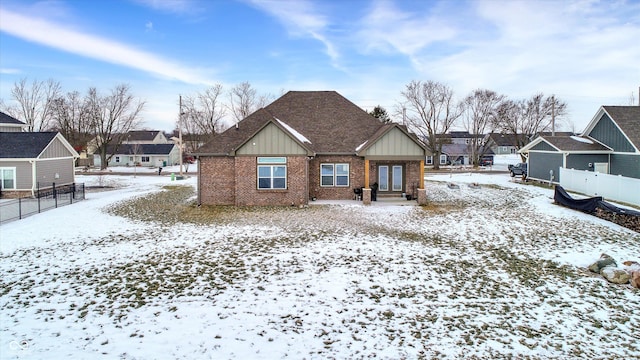 view of snow covered rear of property