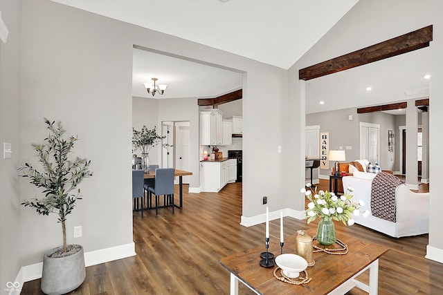 living room with lofted ceiling, dark hardwood / wood-style flooring, and an inviting chandelier