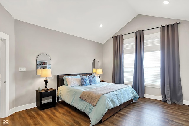 bedroom with vaulted ceiling and dark hardwood / wood-style floors