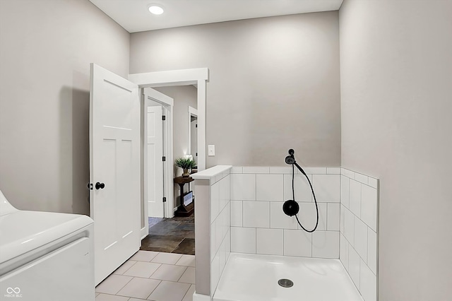 bathroom with washer / clothes dryer and tile patterned flooring