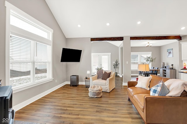 living room with vaulted ceiling with beams, hardwood / wood-style flooring, and a notable chandelier