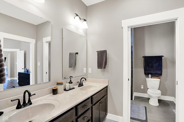 bathroom with vanity, tile patterned floors, and toilet