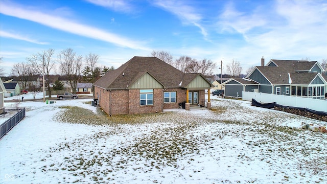 view of snow covered rear of property