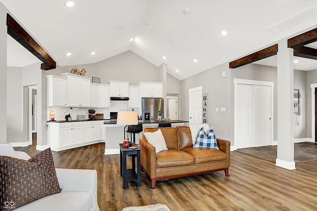 living room with hardwood / wood-style flooring and lofted ceiling