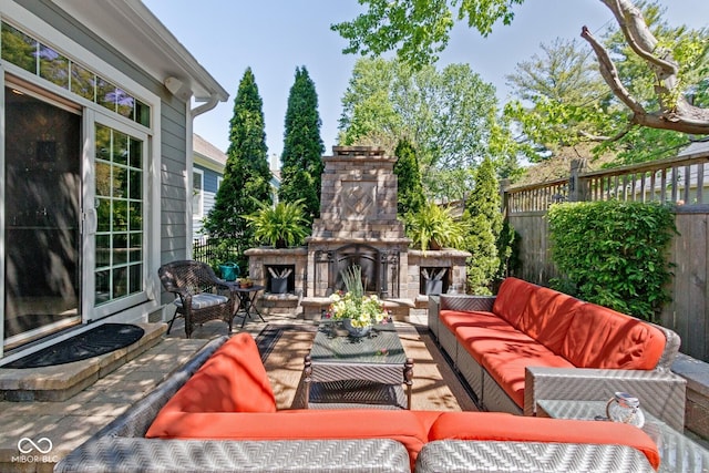 view of patio featuring an outdoor living space with a fireplace