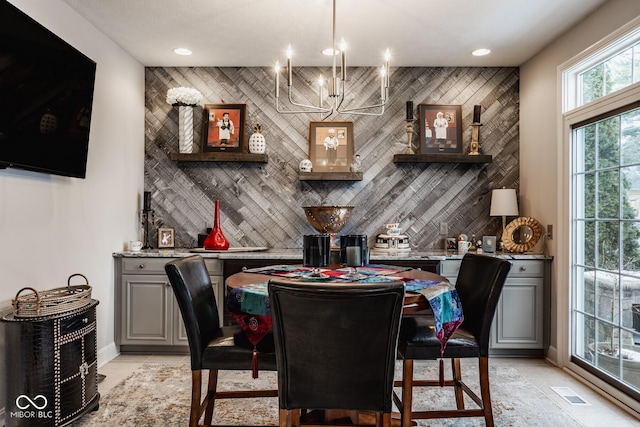 bar featuring light stone countertops, light tile patterned floors, decorative backsplash, and gray cabinetry