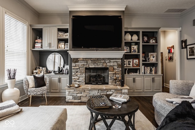 living room featuring ornamental molding, a fireplace, and dark hardwood / wood-style flooring