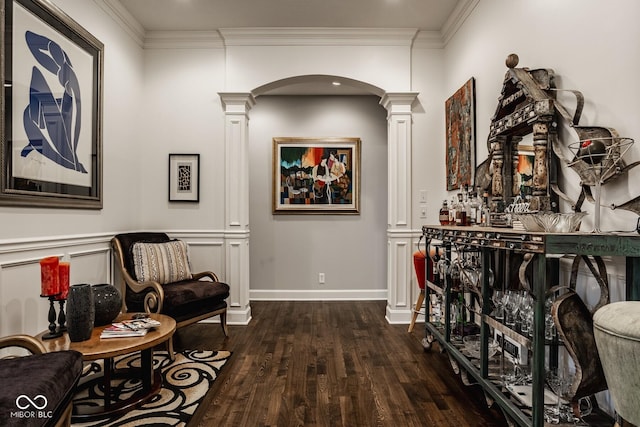 hall featuring ornamental molding, decorative columns, and hardwood / wood-style floors