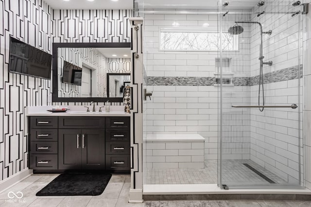 bathroom with vanity and a shower with door