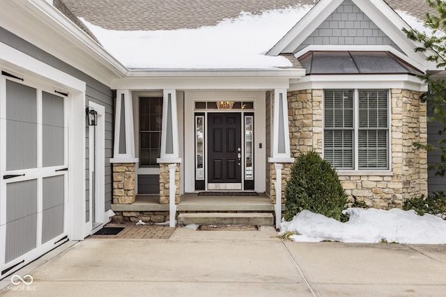 view of snow covered property entrance