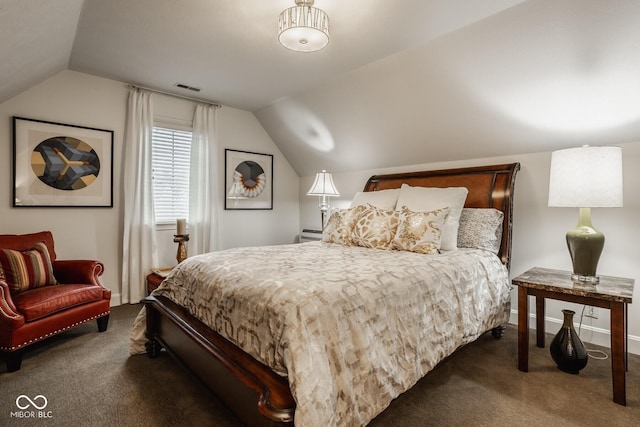 bedroom with lofted ceiling and dark carpet