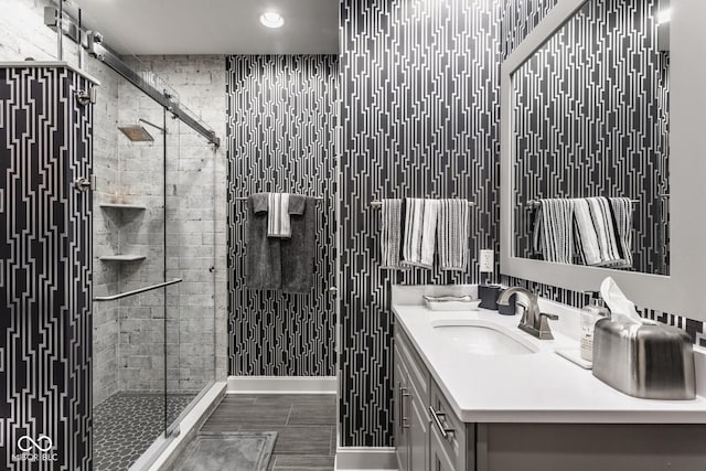 bathroom featuring vanity and a shower with shower door