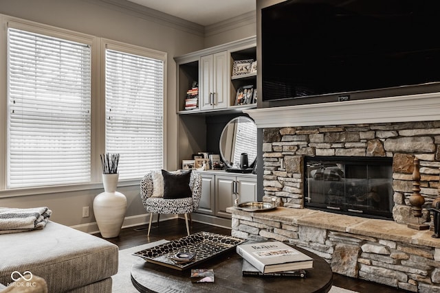 living room featuring a fireplace, dark wood-type flooring, and ornamental molding