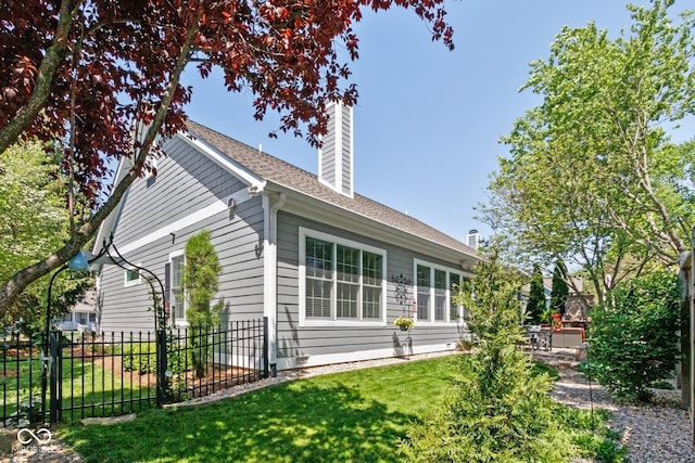 view of side of property featuring a yard