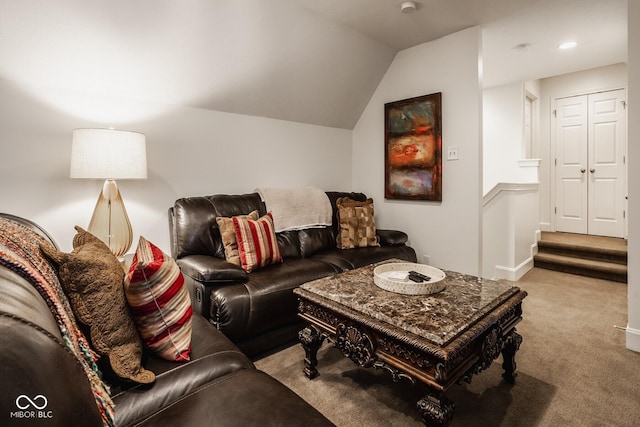 carpeted living room with lofted ceiling