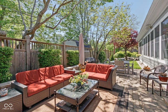 wooden terrace with an outdoor hangout area and a patio area