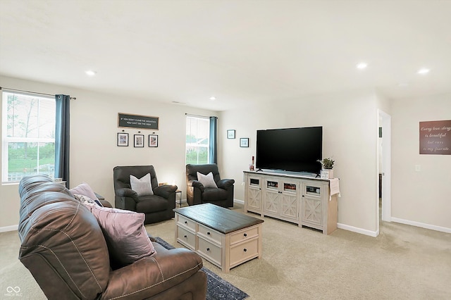 living room with a healthy amount of sunlight and light colored carpet