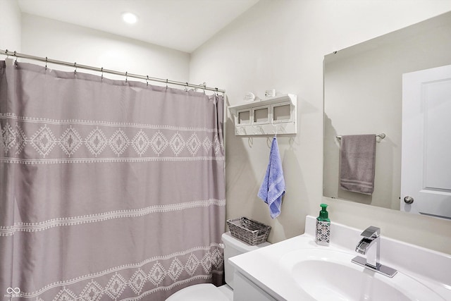 bathroom featuring vanity, toilet, and a shower with shower curtain