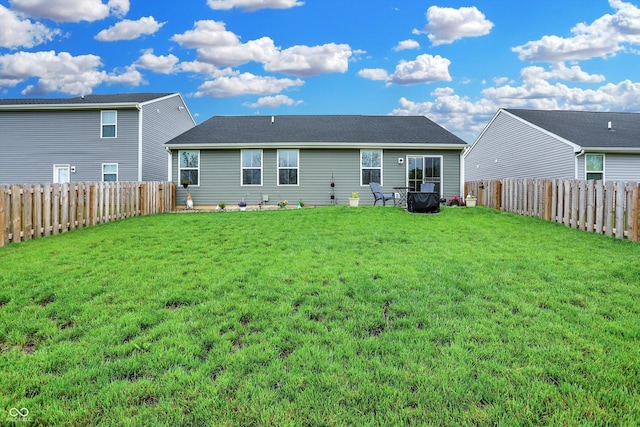 rear view of property with a lawn