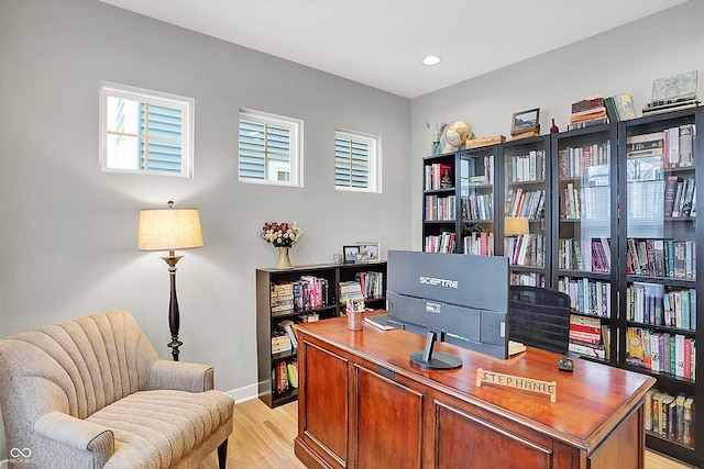 home office with light hardwood / wood-style flooring