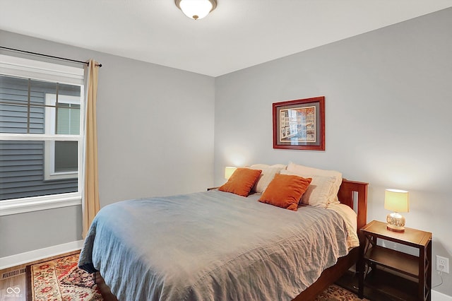 bedroom with wood-type flooring