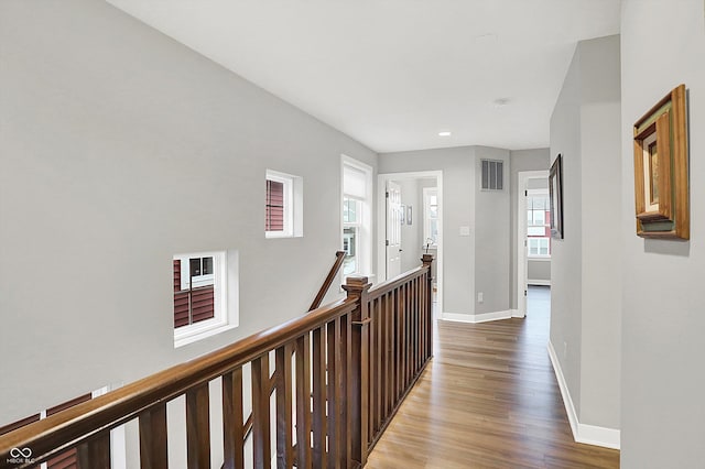 corridor with hardwood / wood-style floors