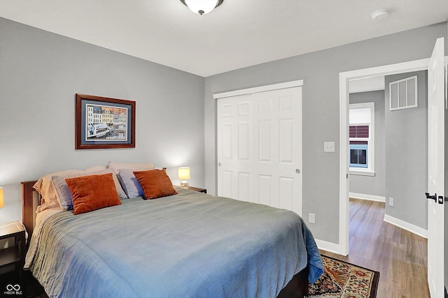 bedroom featuring hardwood / wood-style floors and a closet