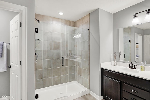 bathroom with vanity, tile patterned flooring, and walk in shower