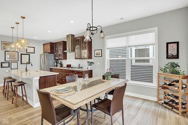 dining space featuring sink and light hardwood / wood-style flooring