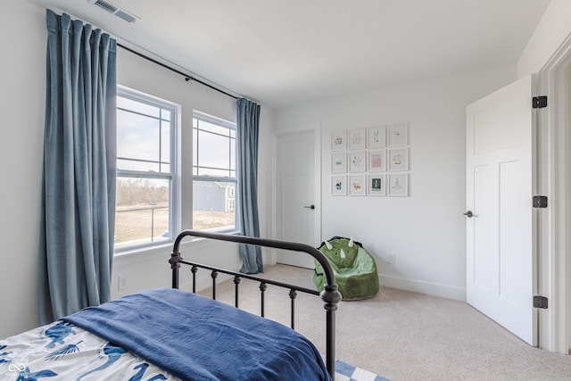 bedroom with multiple windows and carpet