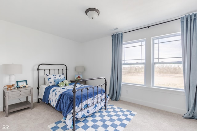 carpeted bedroom featuring multiple windows