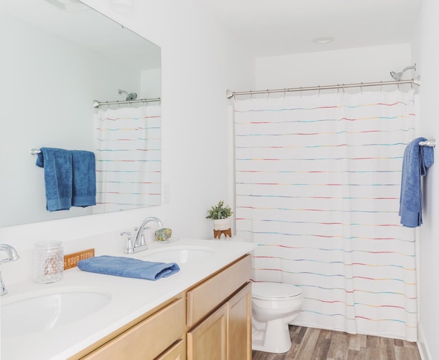 bathroom with hardwood / wood-style flooring, vanity, toilet, and a shower with shower curtain