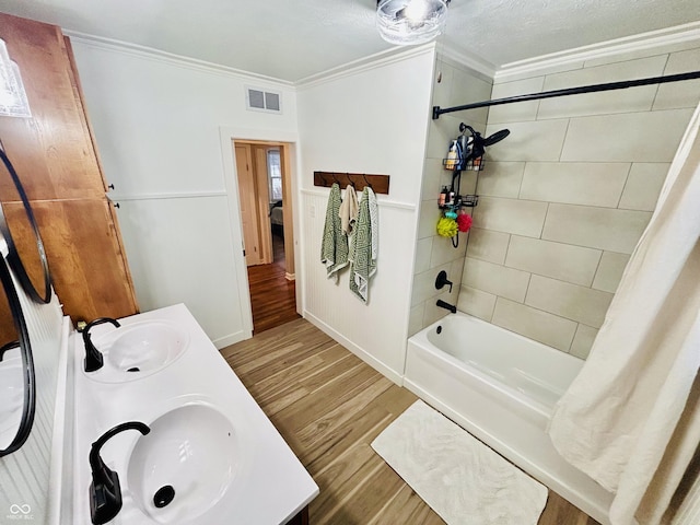 bathroom with shower / tub combo, vanity, wood-type flooring, and ornamental molding