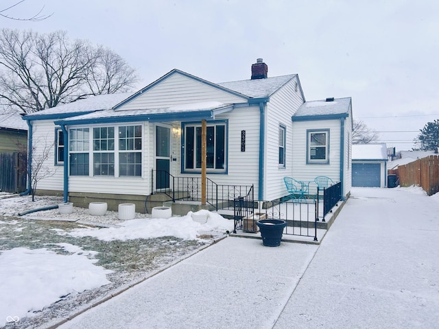 view of front of home featuring a garage and an outdoor structure