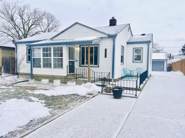 view of front of home with a garage and an outdoor structure