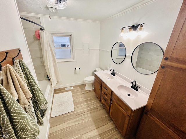 full bathroom with toilet, crown molding, wood-type flooring, shower / tub combo, and vanity