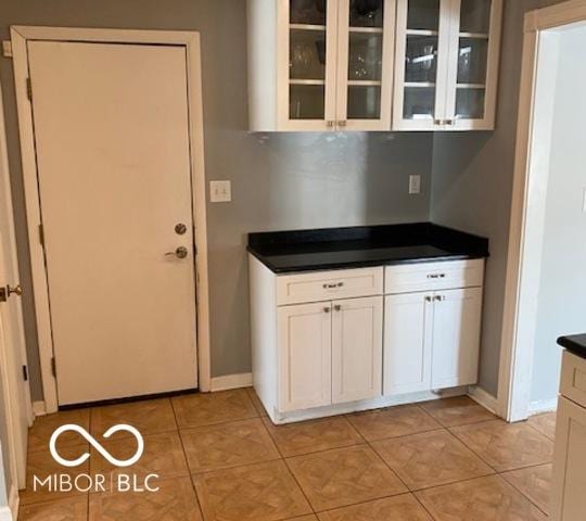 kitchen featuring white cabinetry and light tile patterned floors