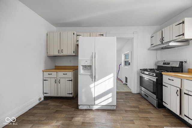 kitchen featuring gas range, dark hardwood / wood-style floors, and white fridge with ice dispenser