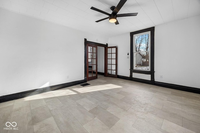 spare room featuring french doors and ceiling fan