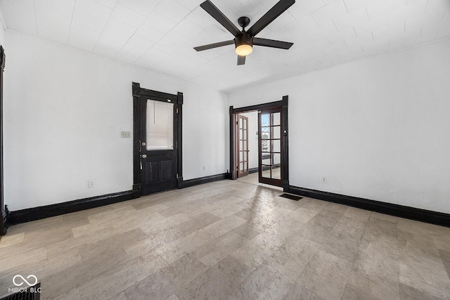 empty room featuring french doors and ceiling fan