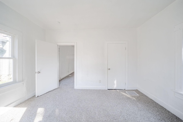 unfurnished room featuring plenty of natural light