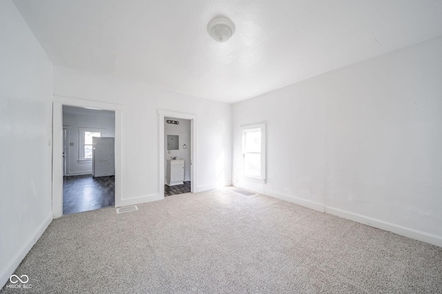 empty room featuring dark colored carpet