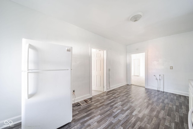 unfurnished room featuring dark wood-type flooring