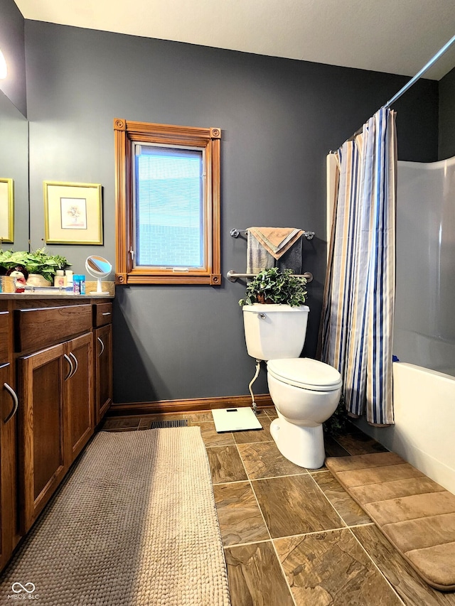 full bathroom featuring shower / bathtub combination with curtain, vanity, and toilet