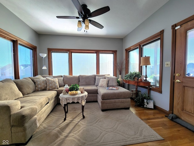 living room with ceiling fan and light wood-type flooring