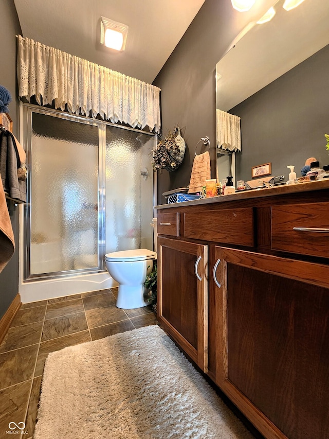 bathroom with toilet and an enclosed shower